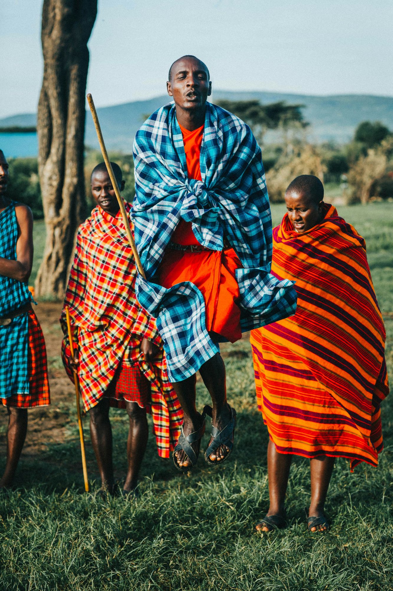 Maasai men in red shukas performing the jumping dance