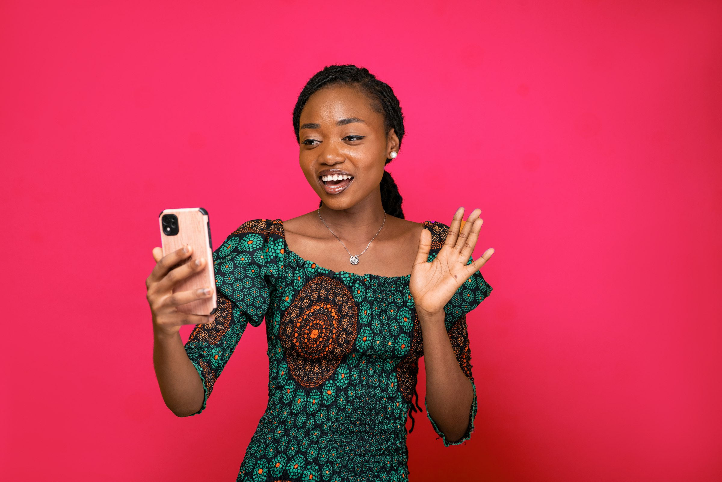 A young woman smiling at her smartphone